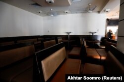 A worker stands amid deserted food outlet, after the provincial government in the southern province of Sindh decided to shut markets, restaurants, public beaches and discouraged large gatherings amid the outbreak of the coronavirus in Karachi.