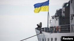 A Ukrainian Navy sailor stands guard on the "Slavutych" flagship in Sevastopol on March 18. The ship was seized by pro-Russian forces four days later. 