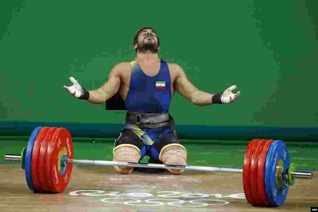 Kianoush Rostami of Iran reacts after setting a new Olympic record during the men's 85-kilogram Group A category final.