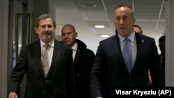 Kosovo's prime minister, Ramush Haradinaj (right), walks with the European Union's enlargement commissioner, Johannes Hahn, upon his arrival in Pristina on December 3.