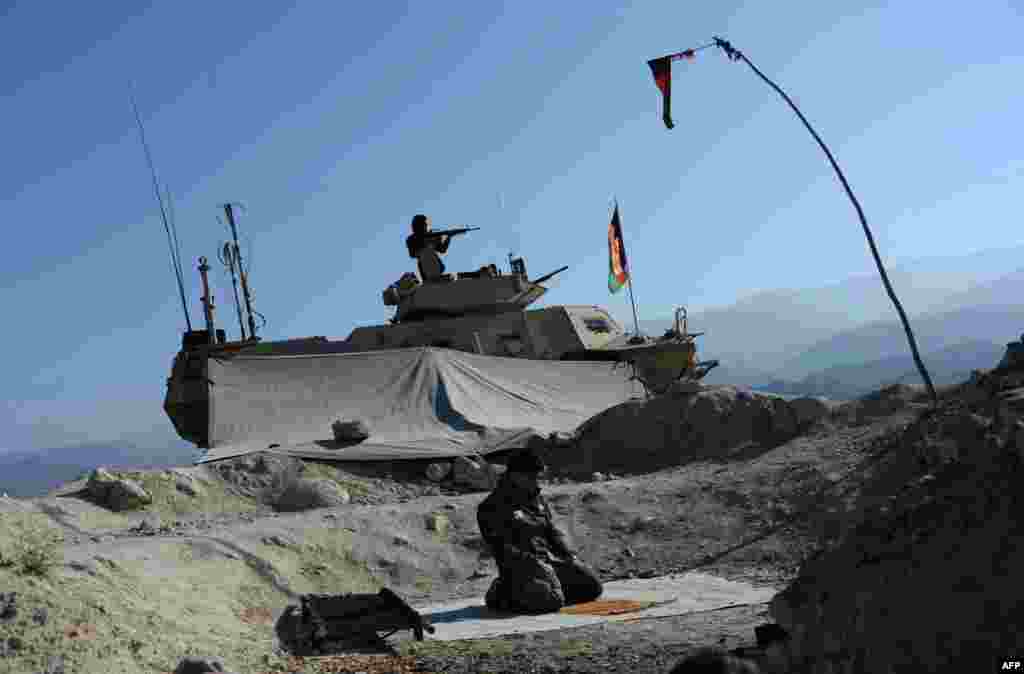 A member of the Afghan security forces prays during an ongoing operation against militant groups in Achin district of Nangarhar Province. (AFP/Noorullah Shirzada)