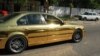 A gold-colored sedan is one of the ostentatious cars on the streets of Grozny.