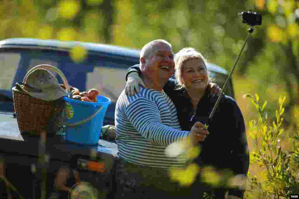 A couple gathers mushrooms in Russia's Kostroma region. (Vladimir Smirnov/TASS)