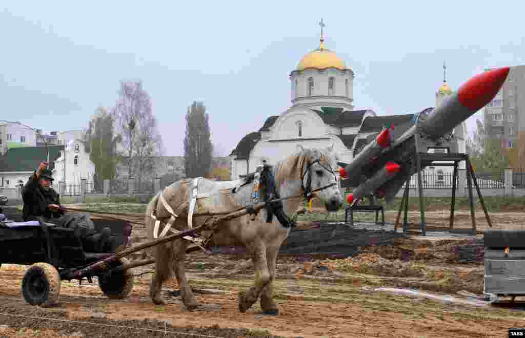 A man on a cart passes the construction site for an open-air museum of military equipment in Zhytkavichy, Belarus. (TASS/Viktar Drachev)