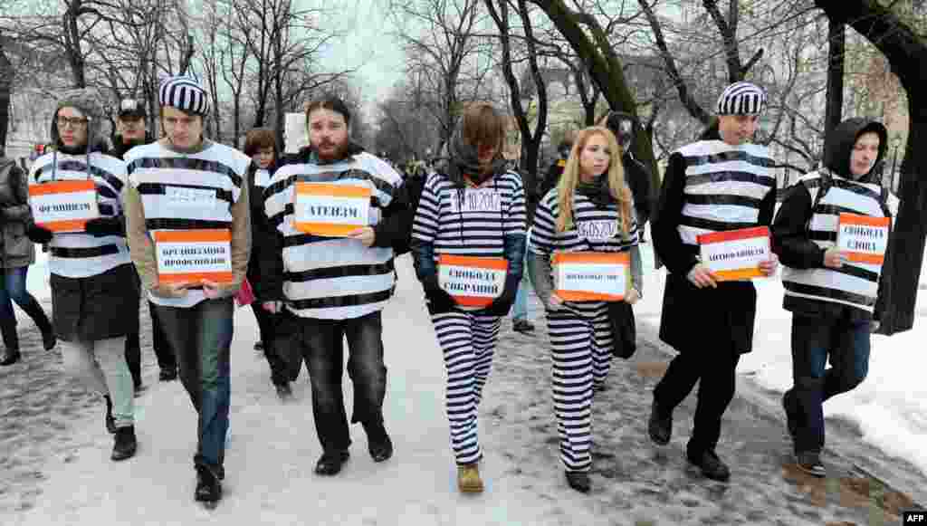 Russian opposition activists dressed as prisoners walk in central Moscow as they rally to demand freedom for political prisoners on December 1. (AFP/Andrey Smirnov)