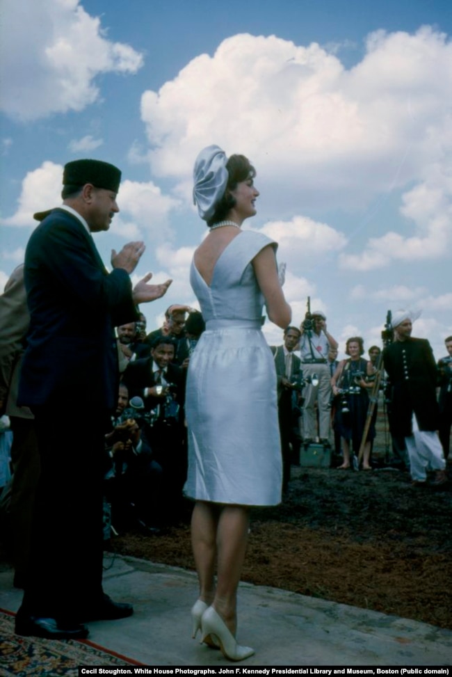 Jacqueline Kennedy and President Mohammad Ayub Khan watch the parade. The first lady later complimented Khan on his traditional fur hat, and the president gifted it to her.