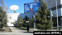 Turkmenistan – The building of TurkmenTelekom behind a billboard advertisement for TMCELL, Ashgabat, 10Feb2011