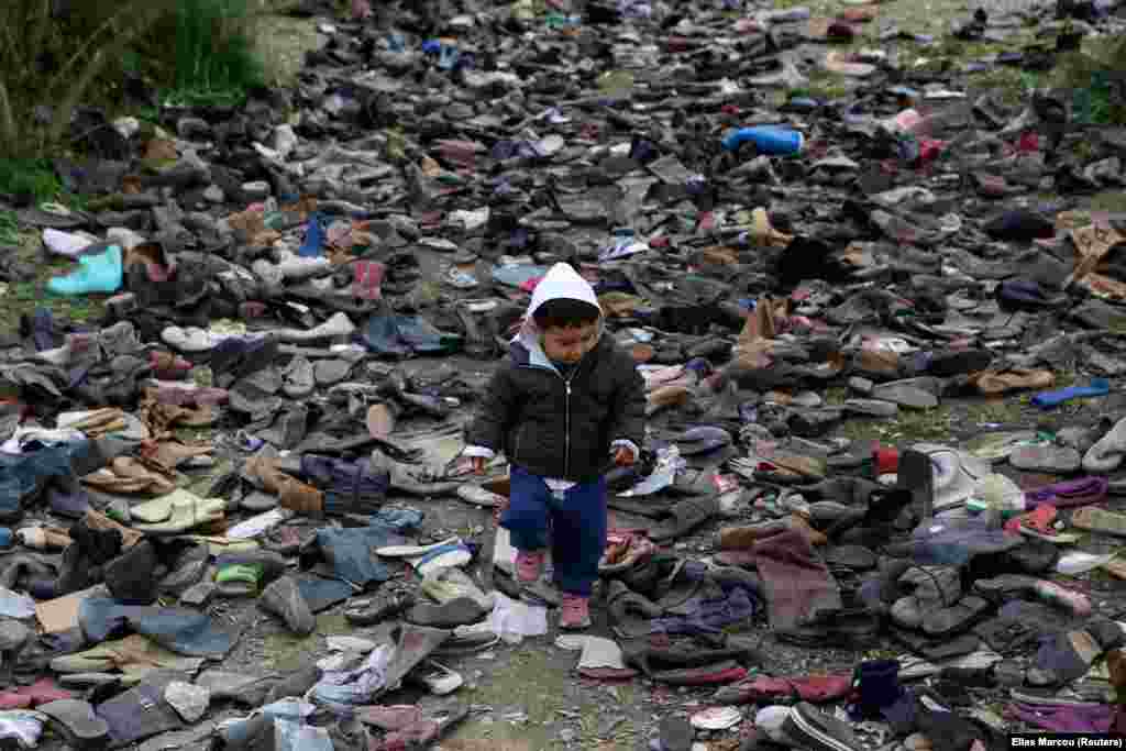 A boy walks among pairs of shoes next to the Moria camp for refugees and migrants on the island of Lesbos, Greece. (Reuters/Elias Marcou)&nbsp;