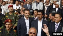 Yemeni President Ali Abdullah Saleh waves to supporters during a rally in Sanaa on April 22.