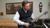 Playing a guitar at home in Novy Petrovtsy (courtesy yanukovych.com.ua)