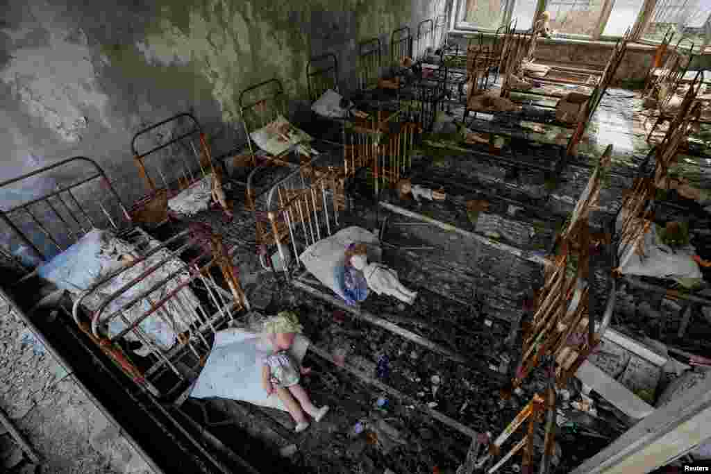 Dolls, which were placed by a visitor, lie in rusty beds at a kindergarten in the abandoned city of Pripyat near the Chernobyl nuclear power plant in Ukraine. (Reuters/Gleb Garanich)