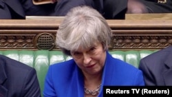 London, Britain - British Prime Minister Theresa May / British Prime Minister Theresa May reacts as Jeremy Corbyn speaks, after she won a confidence vote, after Parliament rejected her Brexit deal, in London, Britain, January 16, 2019, in this screen grab