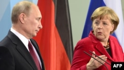 Germany -- Chancellor Angela Merkel (R) speaks next to Russian President Vladimir Putin during a press conference in Berlin, 01Jun2012