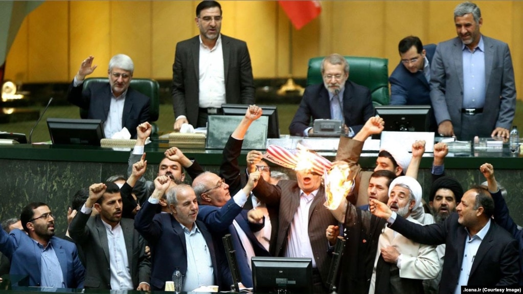 Iranian MPs burning a US flag and a copy of JCPOA in the parliament in Tehran, May 9, 2018