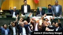 Iranian MPs burning a US flag and a copy of JCPOA in the parliament in Tehran, May 9, 2018