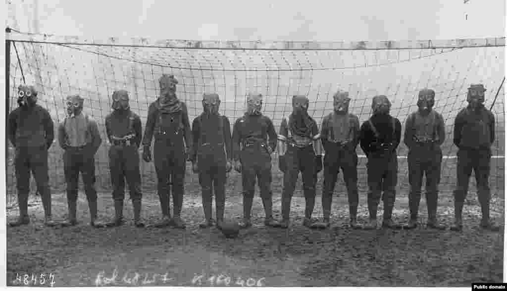 A soccer team of British soldiers dons gas masks during World War I in northern France in 1916.