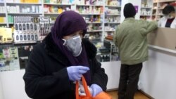 Iran -- An Iranian woman wears a protective mask at a drug store in Tehran, February 25, 2020.