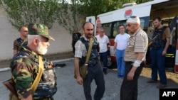 Armenia -- Pavel Manukian (C) and other gunmen standing by an ambulance car at the yard of Erebuni police station in Yerevan seized by them, 17Jul2016.