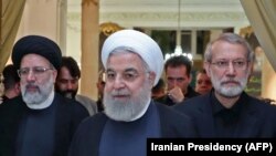 A handout picture provided by the Iranian presidency on September 4, 2019 shows President Hassan Rouhani (Center) before giving a speech after meeting with the Iranian Judiciary chief Ebrahim Raeesi (Left) and parliament speaker Ali Larijani.