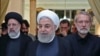 A handout picture provided by the Iranian presidency on September 4, 2019 shows President Hassan Rouhani (Center) before giving a speech after meeting with the Judiciary chief Ebrahim Raeesi (Left) and parliament speaker Ali Larijani (Right)