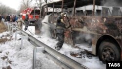 Ukraine--Fire fighters trying to put out blaze on an inter-city bus in the Donetsk Region, eastern Ukraine, 12Feb2009