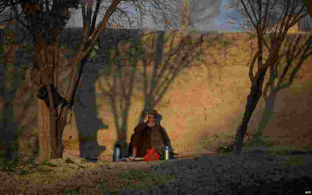 An Afghan farmer drinks tea as he rests after work on the outskirts of Mazar-e Sharif. (AFP/Farshad Usyan)