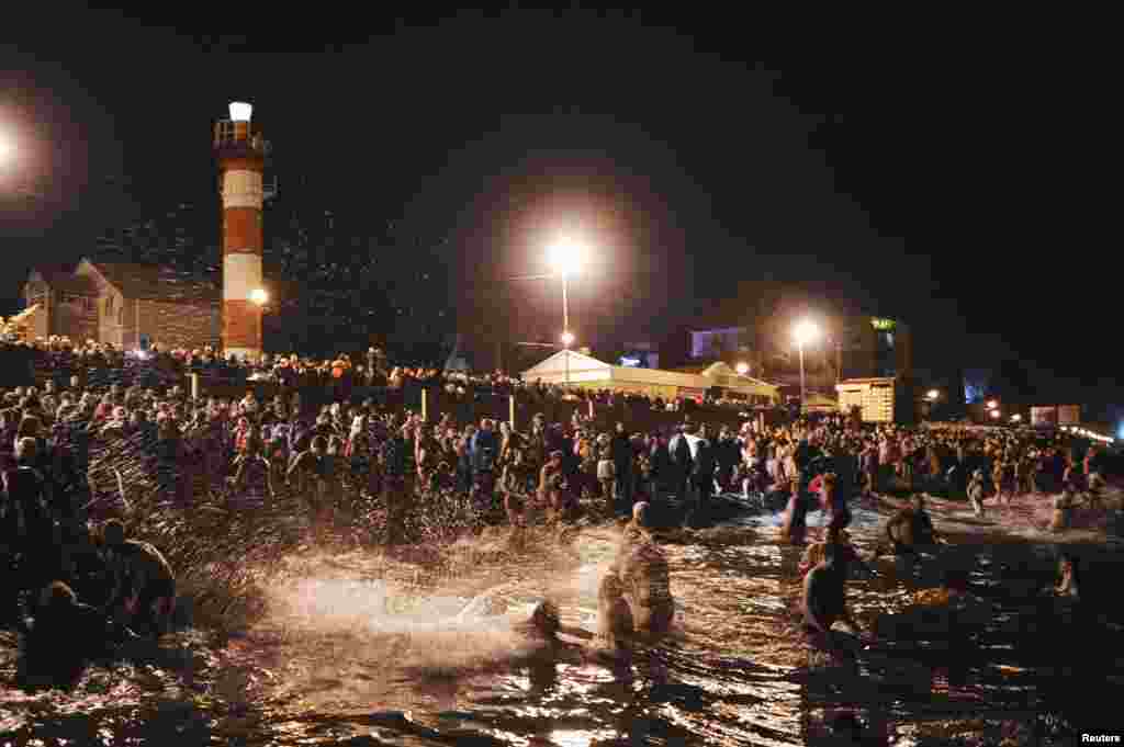 Russians gather to bathe in the Black Sea to mark Epiphany in the southern city of Sochi. (Reuters/Nina Zotina)