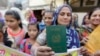 A Hindu refugee who migrated from Pakistan's Sindh Province of Pakistan shows her passport in India. (file photo)