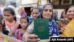 A Hindu refugee who migrated from Pakistan's Sindh Province of Pakistan shows her passport in India. (file photo)