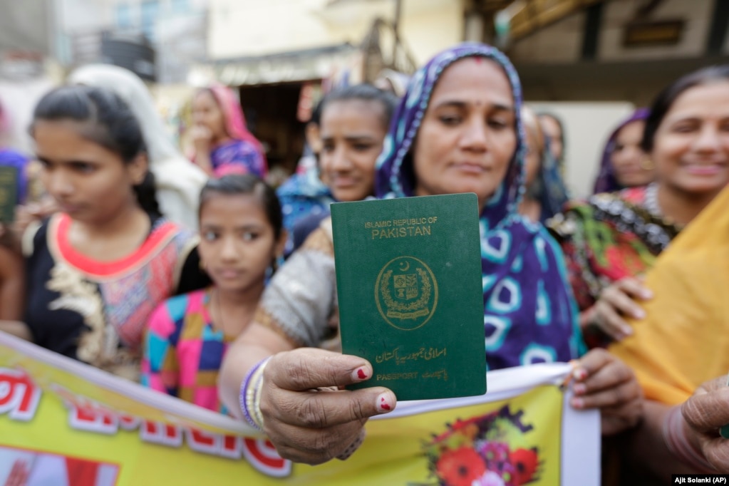 A Hindu refugee who migrated from Sindh Province in Pakistan displays her passport in Ahmadabad, India.