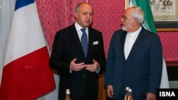 French Foreign Minister Laurent Fabius meets with his Iranian counterpart, Javad Zarif, in Lausanne on March 28.