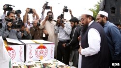 File photo of Hafiz Saeed collecting donations for Falah-e Insaniyat Foundation.