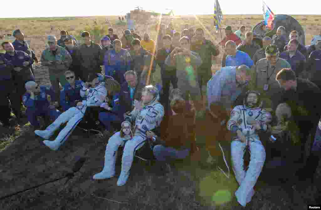 International Space Station crew members Jeff Williams of the United States (left), and Aleksei Ovchinin (center) and Oleg Skripochka of Russia rest after landing on the Kazakh steppes on September 7 after finishing a 172-day mission aboard the orbiting station. (Reuters/Maxim Shipenkov)