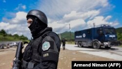 A Kosovar police officer with a special unit helps secure the area after an operation in the north of the country on May 28. 