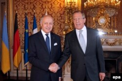 French Foreign Affairs Minister Laurent Fabius (left) greets his Russian counterpart, Sergei Lavrov, in Paris on February 24.
