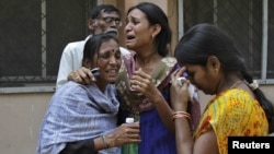 Women outside a mortuary in the southern Indian city of Hyderabad mourn the death of a relative who was killed in one of the February 21 explosions.