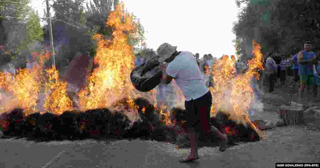 A flaming barricade in Koi-Tash village. Atambaev was initially wanted for charges that included corruption during his 2011-2017 presidency -- charges he said were politically motivated. After a special forces policeman was shot dead on the night of August 8, Kyrgyz officials said he would now also face questioning over that death at his residence.&nbsp;