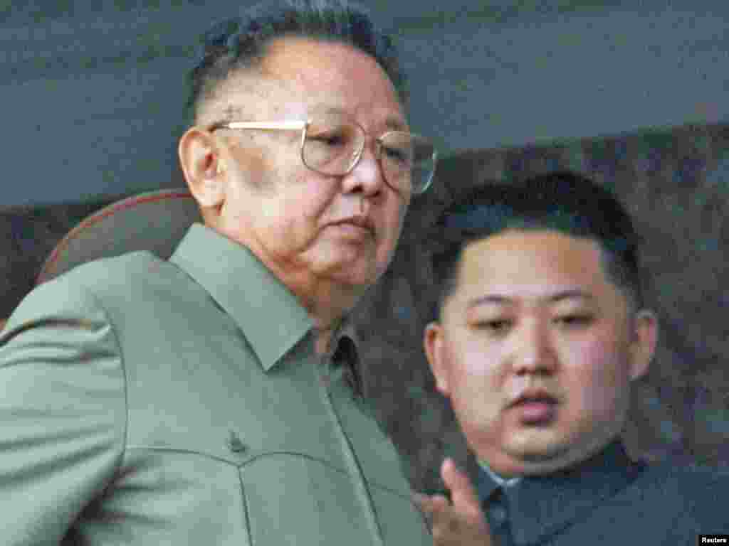 Kim Jong Il (left) and his youngest son and successor, Kim Jong Un, watch a parade to mark the 65th anniversary of the founding of the Workers' Party in Pyongyang in October 2010.