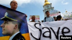 Activists in Kyiv hold placards and banners demanding the release of Ukrainian woman pilot Nadiya Savchenko during a protest on July 11.