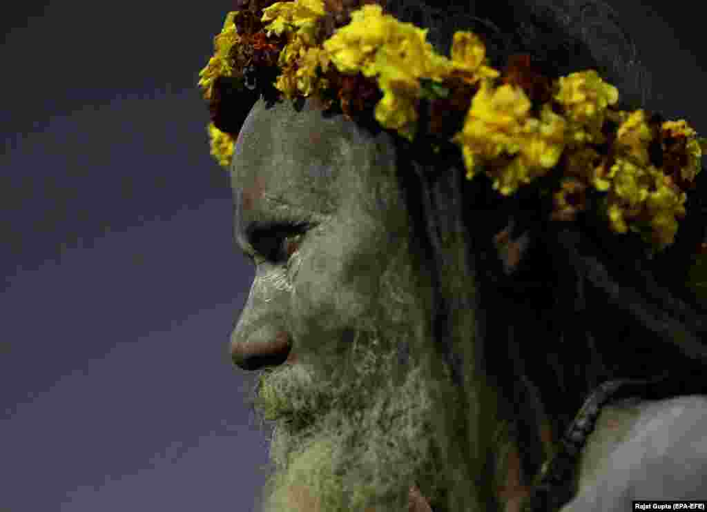 An Indian Naga Sadhus, or naked holy man, participates in a procession during the Kumbh Mela festival in Allahabad. (epa-EFE/Rajat Gupta)