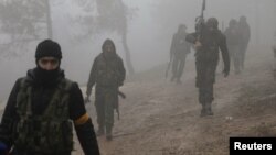 Turkish-backed Free Syrian Army fighters are seen near Mount Barsaya, northeast of Afrin, Syria, last week.