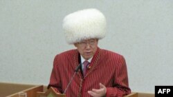 United Nations Secretary-General Ban Ki-moon wearing a traditional Turkmen dress delivers a speech at the University for Humanities and Development in Ashgabat in June.