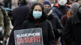 France, Paris, A woman holds a placard reading "enough of islamophobia" as protesters demonstrate against a bill dubbed as "anti-separatism", in Paris on February 14, 2021. 