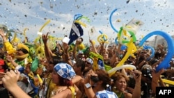 A jubilant crowd in Copacabana Beach, Rio de Janeiro, cheers after the IOC announces on October 2 that their city will host the 2016 Olympics.