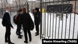 Students and police outside Secondary School No. 127 in Perm following the knife attack in January