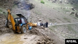 Clearing a flood-damaged road in mid-May