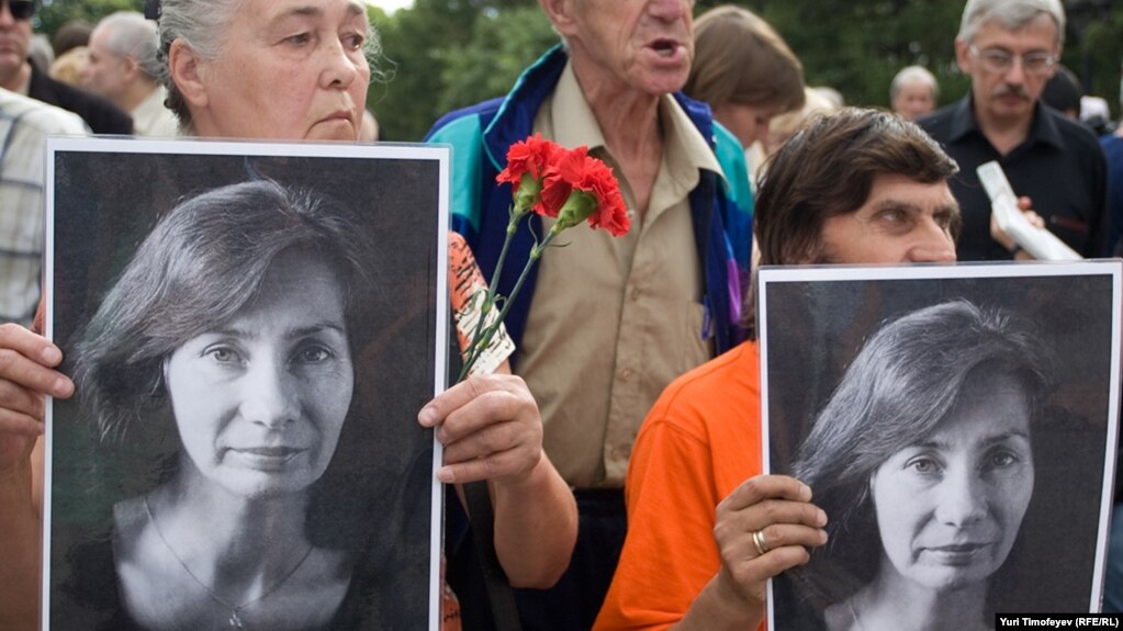 People hold portraits of journalist and human rights activist Natalya Estemirova during a rally in Moscow in July 2009. 
