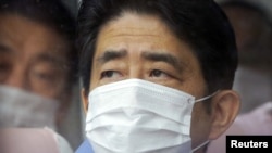 Prime Minister Shinzo Abe inspects the tsunami-crippled Fukushima Daiichi nuclear power plant in Fukushima Prefecture on December 29.