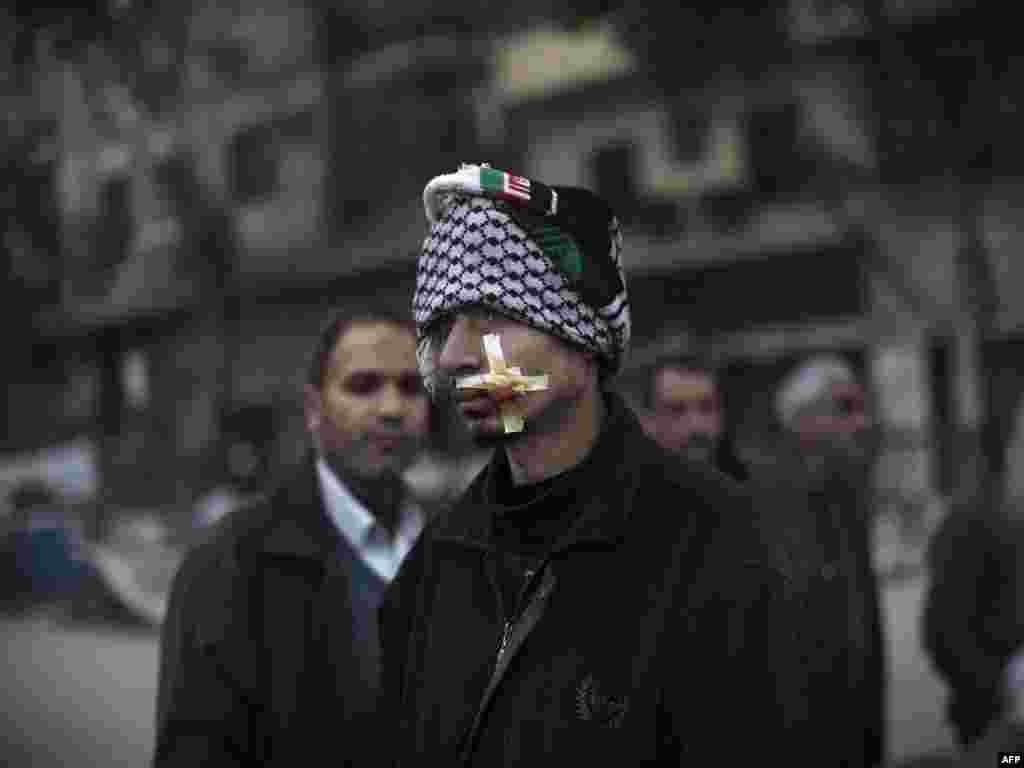 A wounded antigovernment protester stands in Tahrir Square on February 5.