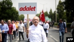 Republican People's Party leader Kemal Kilicdaroglu walks with a placard reading "Justice" during a protest march in Ankara in June.